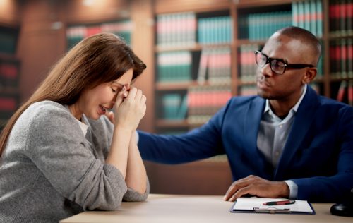 Young Woman Discusses Legal Claim With Attorney During Wrongful Death Consultation Session. Female Client Meets Lawyer